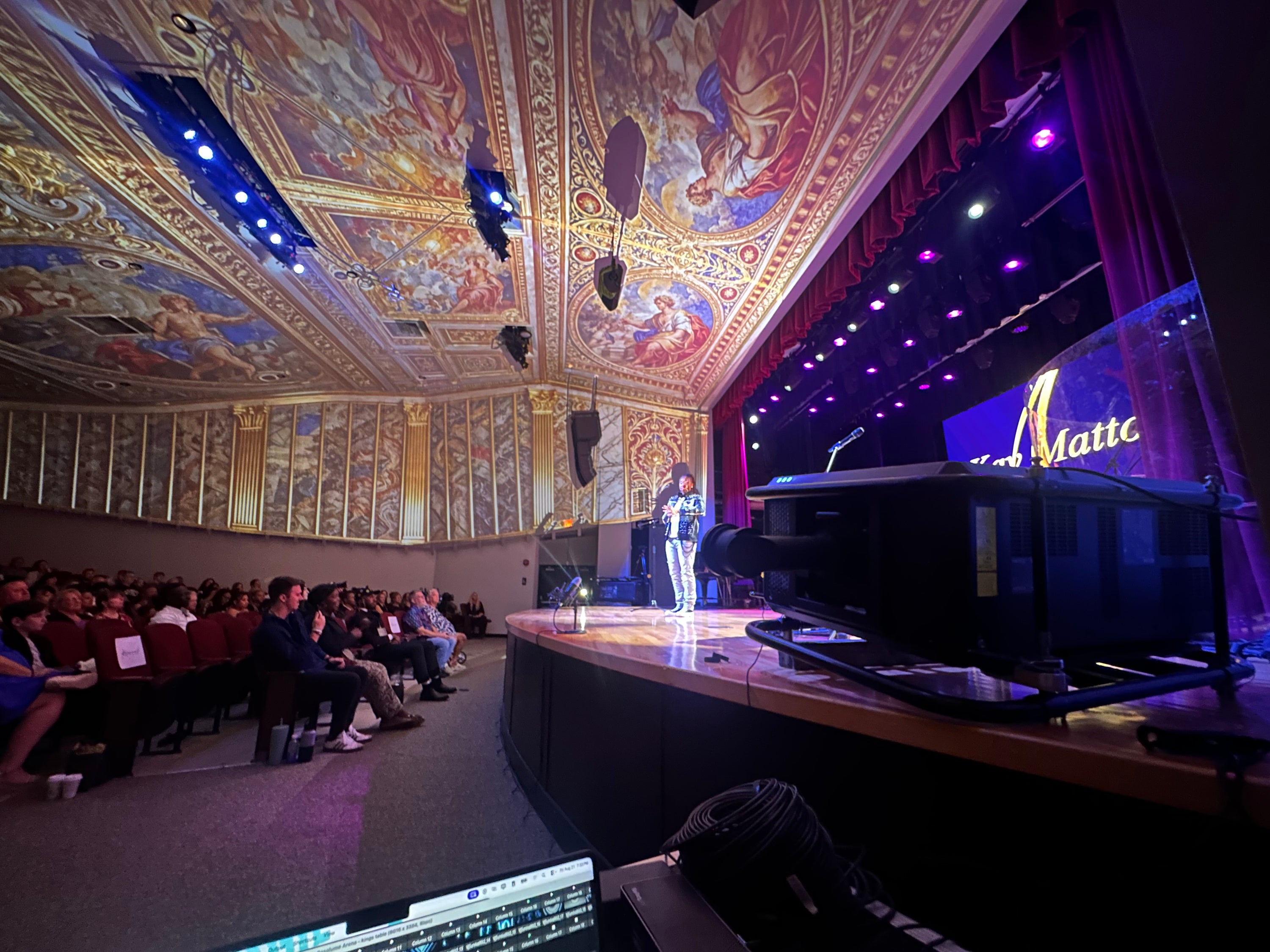Audience watching an immersive ceiling projection show inside a theater