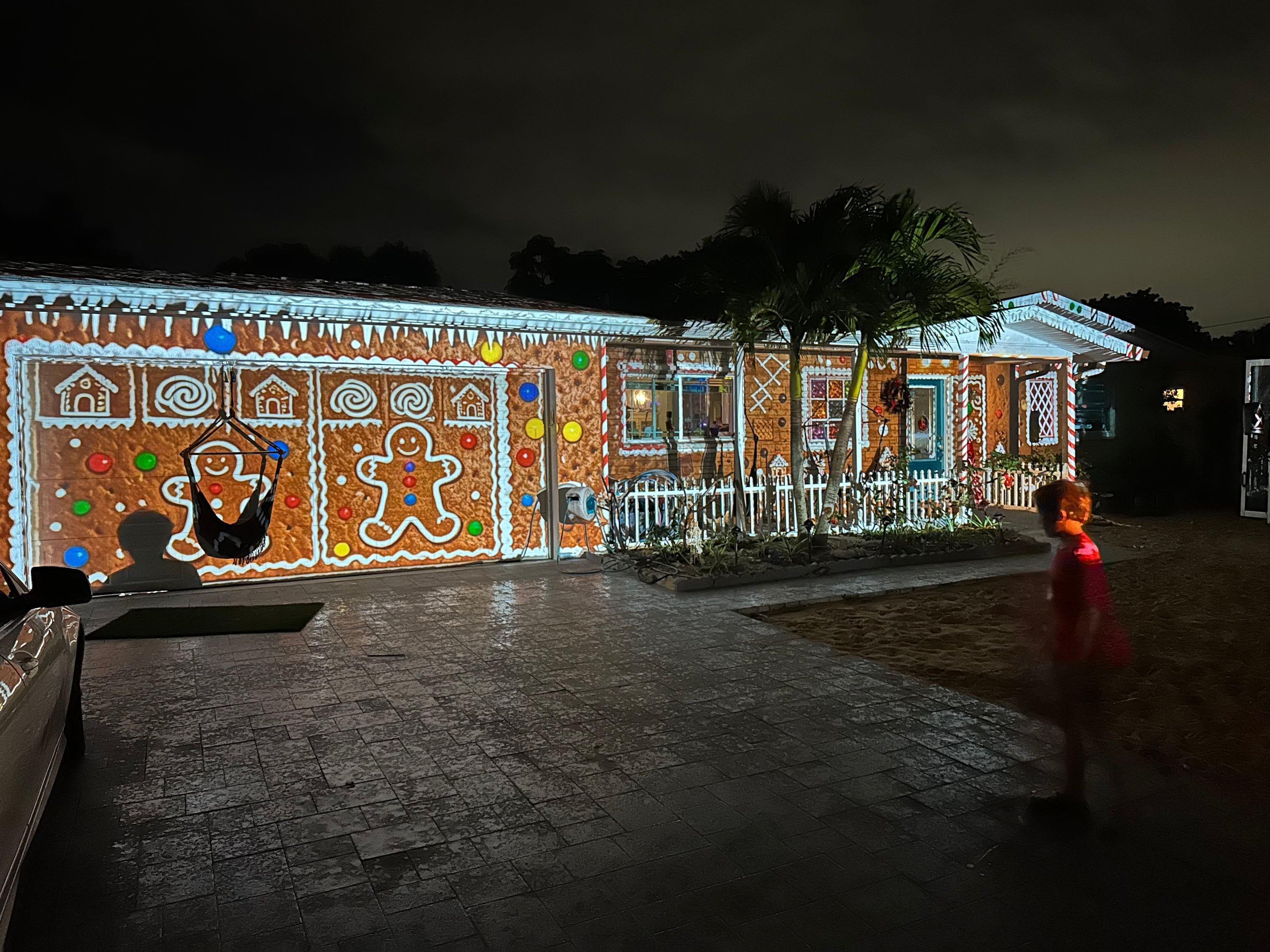 Home turned into a glowing gingerbread house by projection