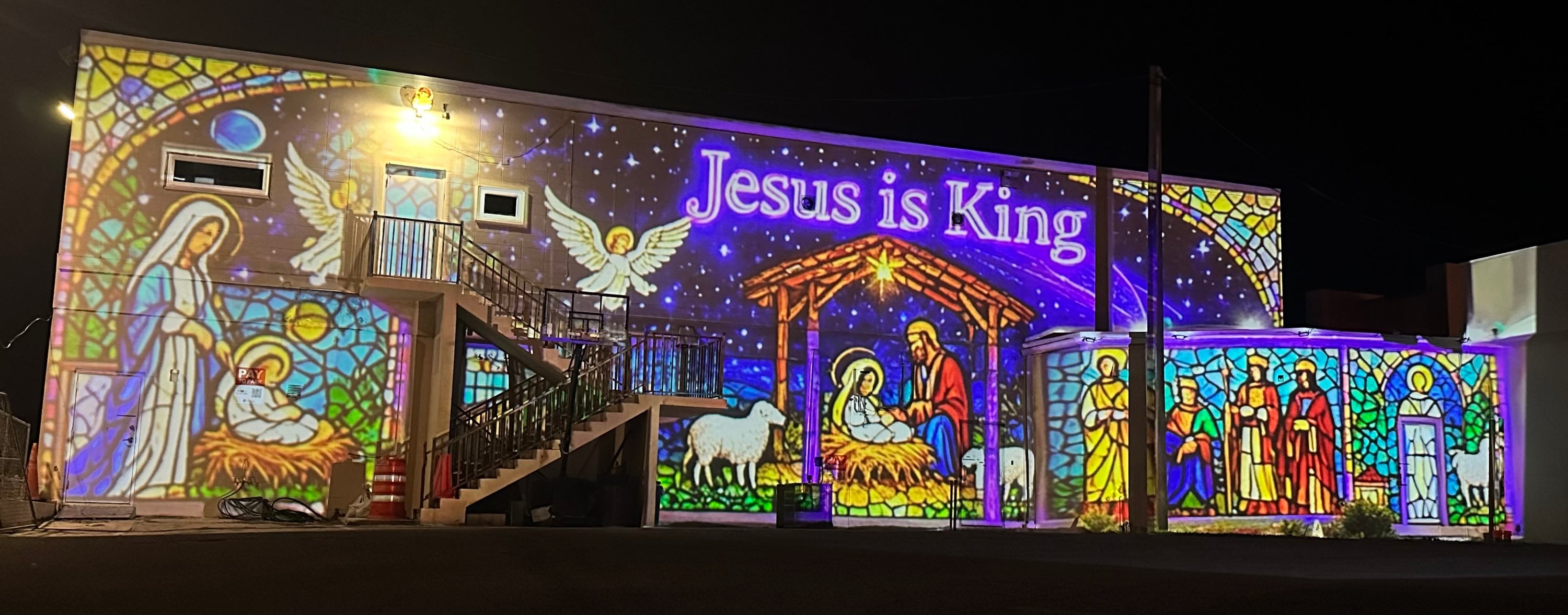 Stained glass angel and nativity projection mapping on a building
