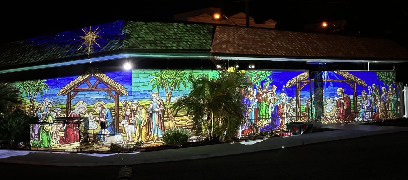 Nativity scene projection wrapping a home at night