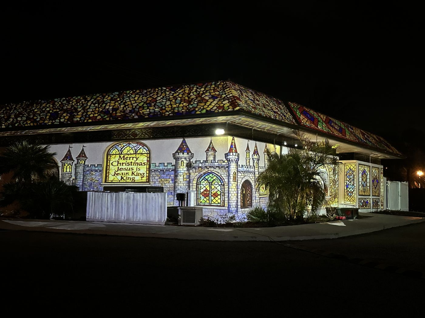 Castle-themed holiday projection show on a house