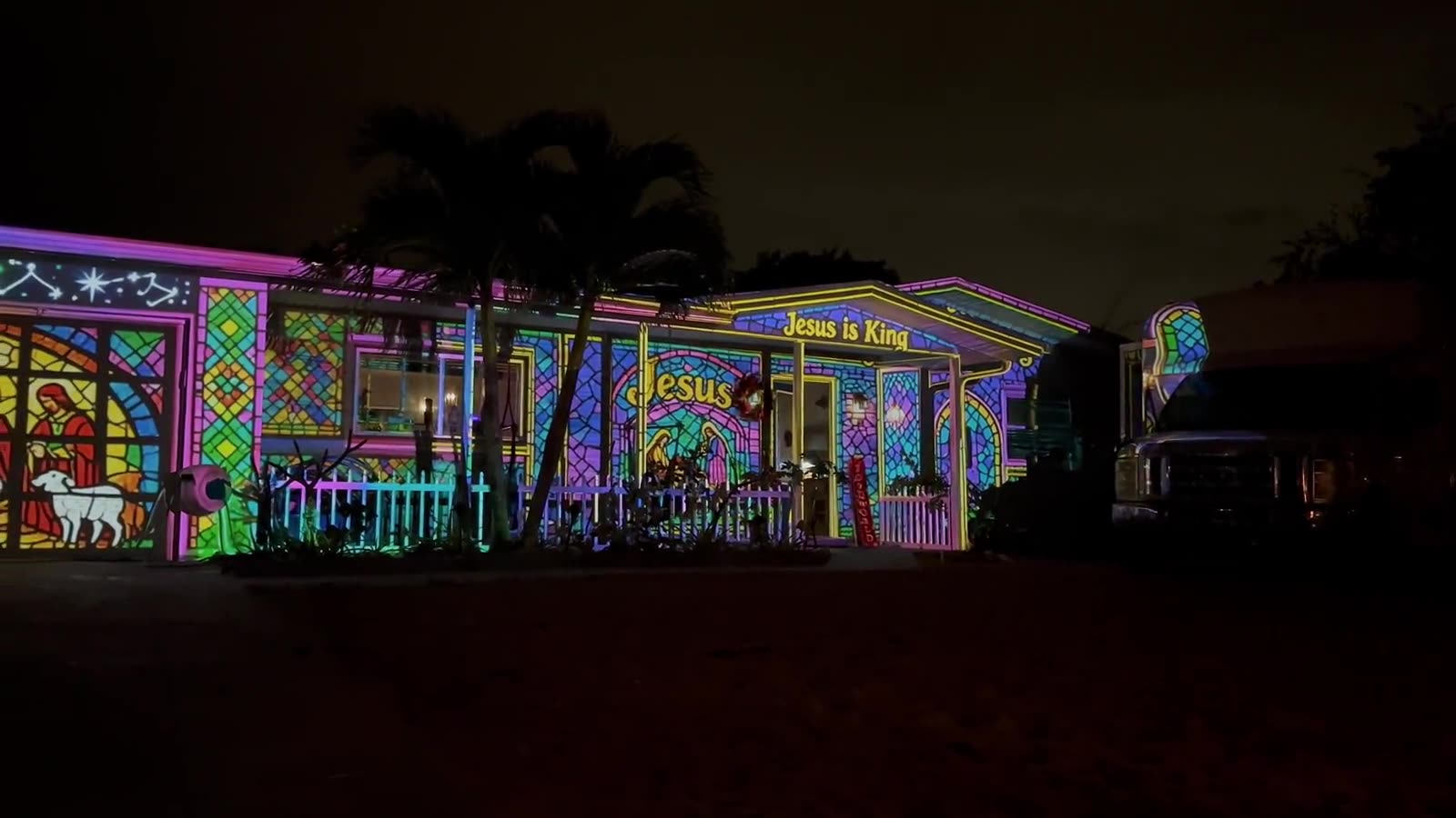 Home transformed by a stained glass Christmas projection show