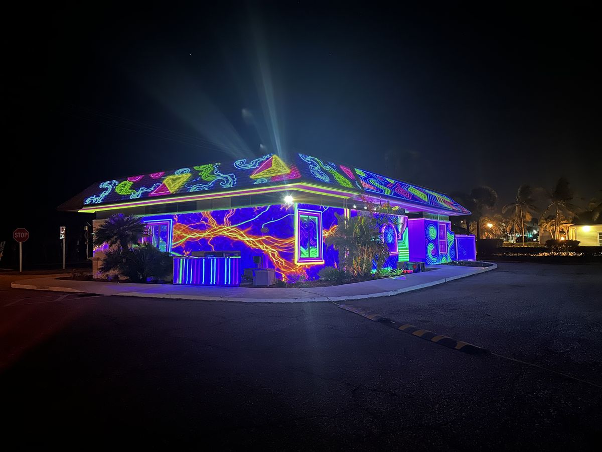 House lit by a Halloween laser projection show from The Spacey Box