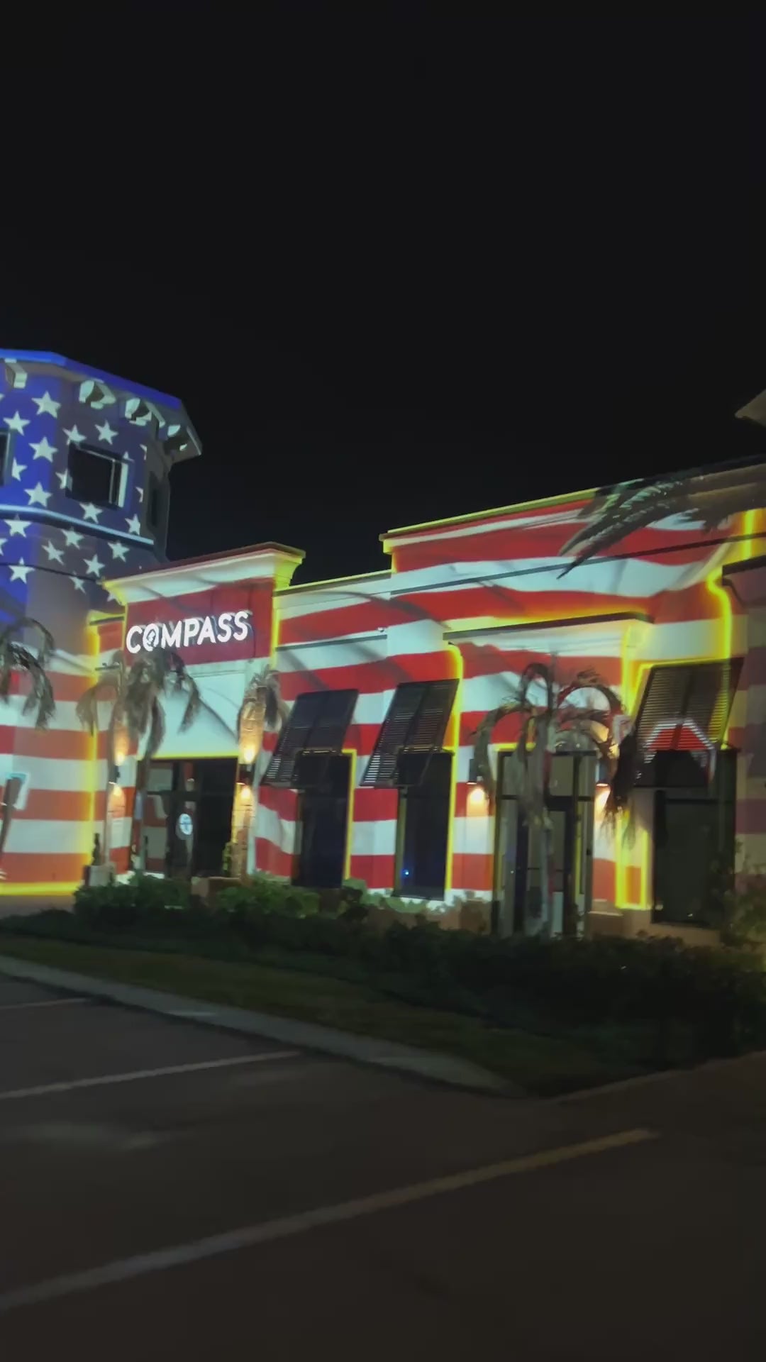 American flag projection mapping across a large venue at night