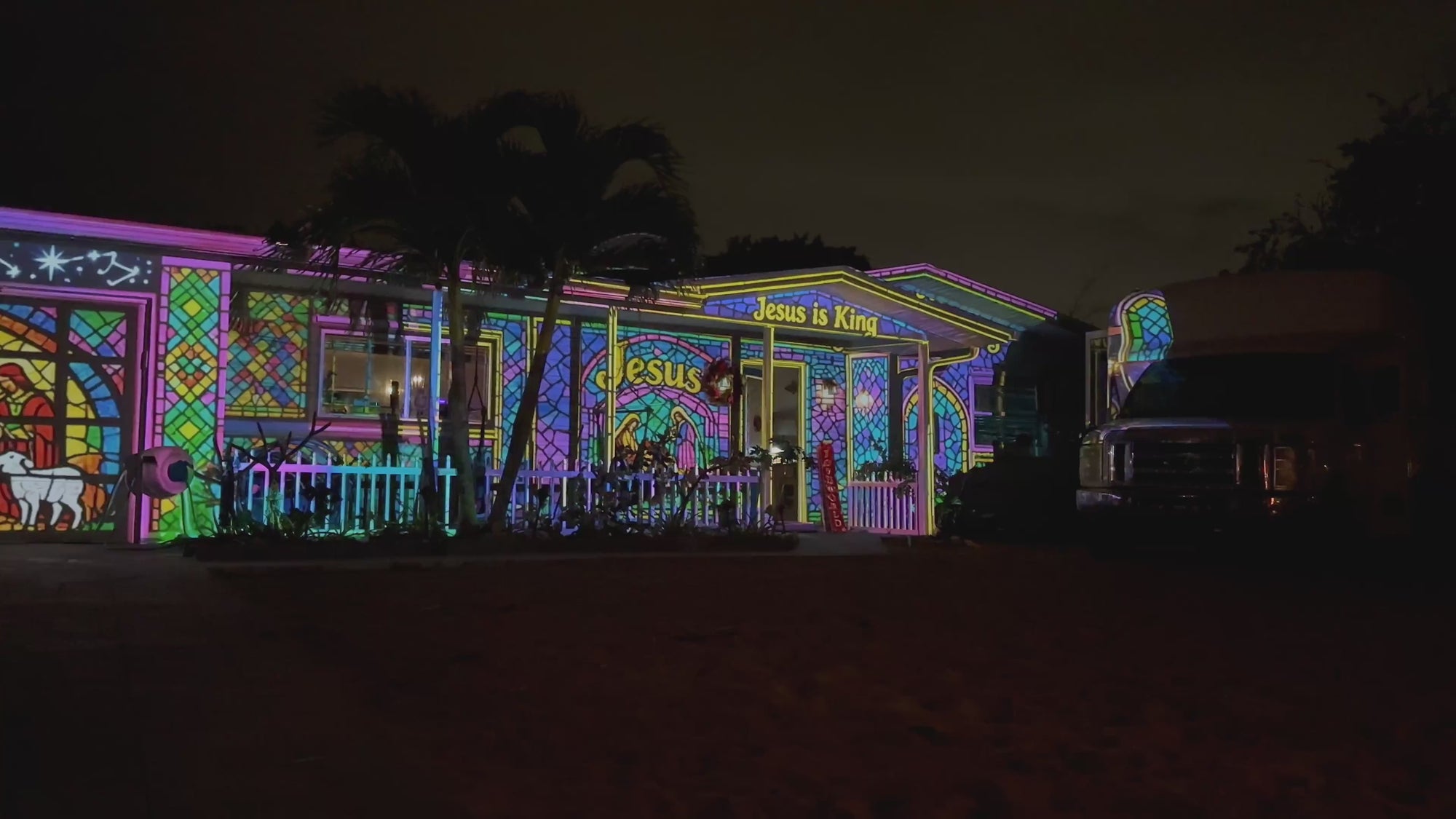 Stained glass nativity projection mapping across a building at night