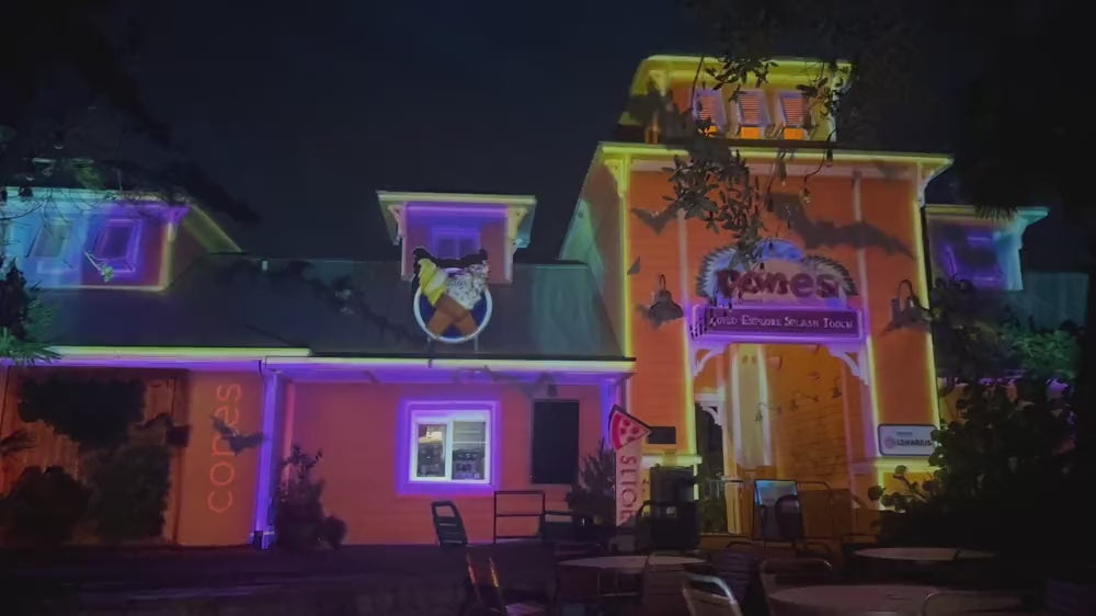 Halloween projection show playing on a house at night